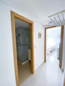 a bathroom with a shower and a glass door at Bellaluz 18.15, La Manga Club Resort in Atamaría