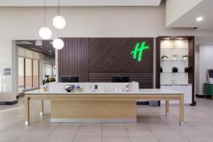 a lobby with a large desk in a building at Holiday Inn Phoenix Airport, an IHG Hotel in Phoenix