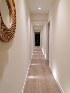 a hallway with white walls and a mirror on the wall at APARTAMENTO CALMA in Logroño