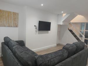 a living room with a couch and a tv at Tribeca Stay in Galway