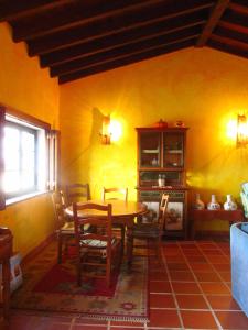 a dining room with a wooden table and chairs at Golf & Surf Holiday House in Casal da Lagoa Seca