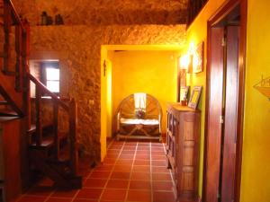 a hallway of a house with yellow walls at Golf & Surf Holiday House in Casal da Lagoa Seca