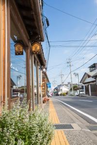 a building on the side of a street at Guest House Kura in Suzaka
