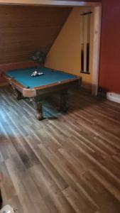a pool table sitting on top of a wooden floor at Camping Funhouse #3 in Tobyhanna
