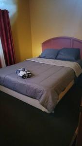 a bedroom with a bed with blue pillows at Camping Funhouse #3 in Tobyhanna