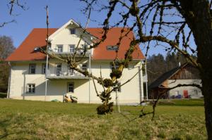 a large white house with a red roof at Goldschmiedsmühle in Lindau