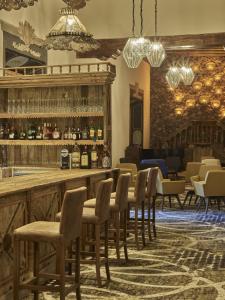 a bar with a bunch of chairs and a counter at Fiesta Americana Hacienda Galindo Resort & Spa in Galindo