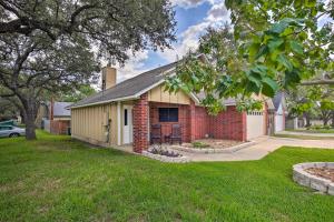 a brick house with a garage in a yard at Family Retreat about 1 Mi to Hill Country Mile! in Boerne