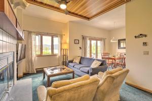 a living room with a couch and a table at Lake Placid Condo with Patio - Walk to Beach! in Lake Placid