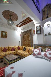 a living room with a couch and a table at Dar Dahab in Fez