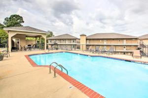 a pool at a hotel with tables and chairs at Lakefront Hot Springs Condo with Balcony and Boat Slip in Hot Springs