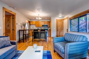 a living room with a couch and a table at Whispering Red Pine Paradise in Park City