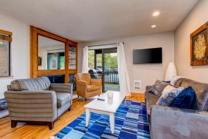 a living room with a couch and a table at Whispering Red Pine Paradise in Park City