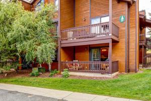 a large house with a balcony and a yard at Whispering Red Pine Paradise in Park City