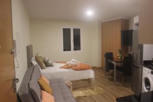 a bedroom with a bed and a couch in a room at Torrinha & Sá in Funchal