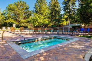 a small swimming pool with chairs and a table at Whispering Red Pine Paradise in Park City +17 photos