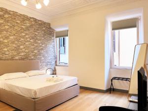 A bed or beds in a room at Pantheon Rome Relais