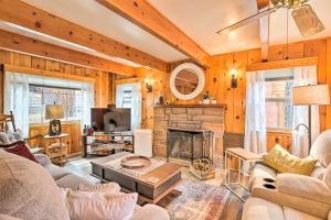 a living room with a couch and a fireplace at Wrightwood Cabin with Cozy Interior! in Wrightwood