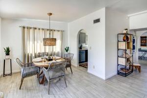 a dining room and living room with a table and chairs at Stylish Tucson Home with Patio and Private Pool! in Tucson