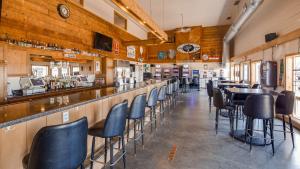 a bar with chairs and tables in a restaurant at SureStay Hotel by Best Western Thomson in Thomson