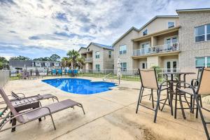 a patio with chairs and a table and a pool at Modern Long Beach Escape about 1 Mi to Shores! in Long Beach