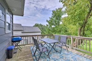 a patio with a table and chairs on a deck at Enchanting Family House with Balcony Less Than 3 Mi to WVU! in Morgantown