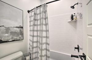 a bathroom with a shower curtain in a bathroom at Modern Mountain Escape Near Slopes, Lakes and Trails in Eden +42 photos