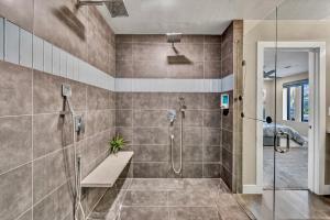 a bathroom with a shower with a glass door at Quiet Contemporary Executive 4BD, 3BA Estate with Pool in Tempe