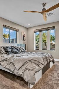 a bedroom with a large bed with a ceiling fan at Quiet Contemporary Executive 4BD, 3BA Estate with Pool in Tempe