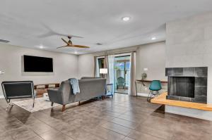 a living room with a couch and a fireplace at Quiet Contemporary Executive 4BD, 3BA Estate with Pool in Tempe
