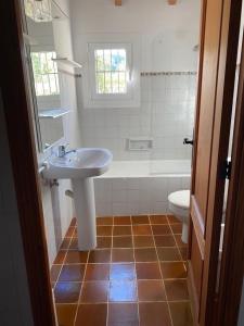 a bathroom with a sink and a tub and a toilet at Can Petrel in Pollença