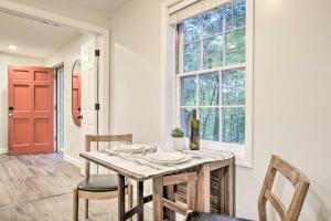 a dining room with a table and chairs and a red door at Dog-Friendly Raleigh Apartment about 5 Mi to Downtown! in Raleigh