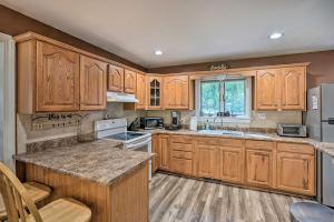a kitchen with wooden cabinets and a counter top at Pet-Friendly Saratoga Springs Home with Pool! in Saratoga Springs