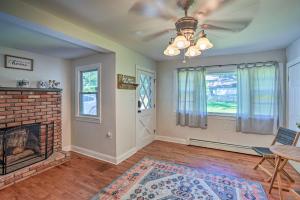 a living room with a brick fireplace and a ceiling fan at Pet-Friendly Saratoga Springs Home with Pool! in Saratoga Springs