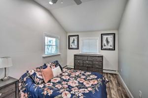 a bedroom with a bed and a dresser and two windows at Pet-Friendly Saratoga Springs Home with Pool! in Saratoga Springs