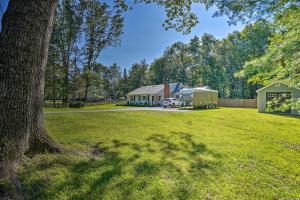 a large yard with a house and a tree at Pet-Friendly Saratoga Springs Home with Pool! in Saratoga Springs