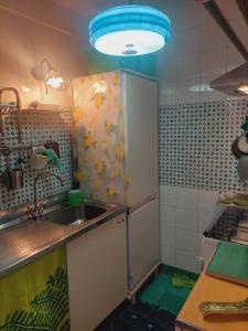 a kitchen with a sink and a refrigerator at La Casa di Rita in Cetara