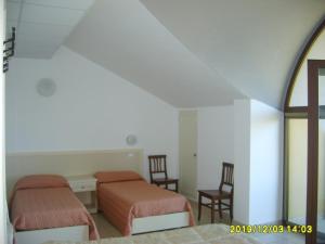 Ένα ή περισσότερα κρεβάτια σε δωμάτιο στο Hotel Giardino San Michele