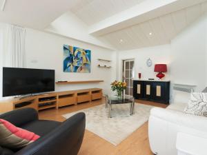 a living room with a couch and a flat screen tv at The Penthouse in Dartmouth