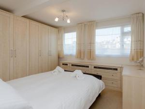 a bedroom with a white bed and a window at The Penthouse in Dartmouth