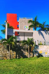 un bâtiment avec des palmiers en face de celui-ci dans l'établissement Hotel Real de Lua, à Xilitla