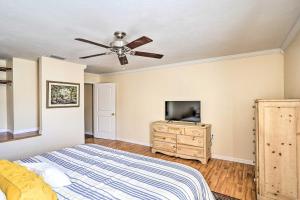a bedroom with a bed and a flat screen tv at Sebring Condo with Game Room Less Than 13 Mi to Raceway in Sebring