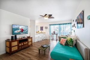 a living room with a couch and a table at Kona Mansions#301 in Kailua-Kona