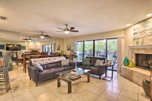 a living room with a couch and a fireplace at Sea La Vie Sunny Indian Rocks Beach Condo! in Clearwater Beach
