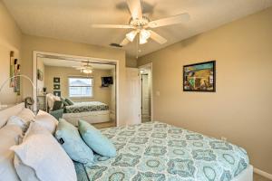 a bedroom with a bed and a ceiling fan at Sea La Vie Sunny Indian Rocks Beach Condo! in Clearwater Beach