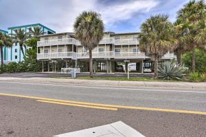 a building with palm trees in front of a street at Sea La Vie Sunny Indian Rocks Beach Condo! in Clearwater Beach