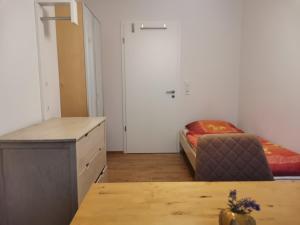 a small room with a bed and a desk at Oktoberfest in Puchheim