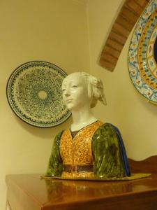 a statue of a woman sitting on a table with plates at Hotel Nuova Italia in Florence