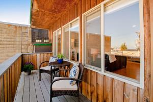 a porch with a table and chairs and a window at Port Angeles Water View Loft in Port Angeles