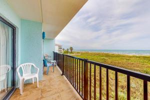a balcony with chairs and a view of the ocean at Continental 201 in South Padre Island